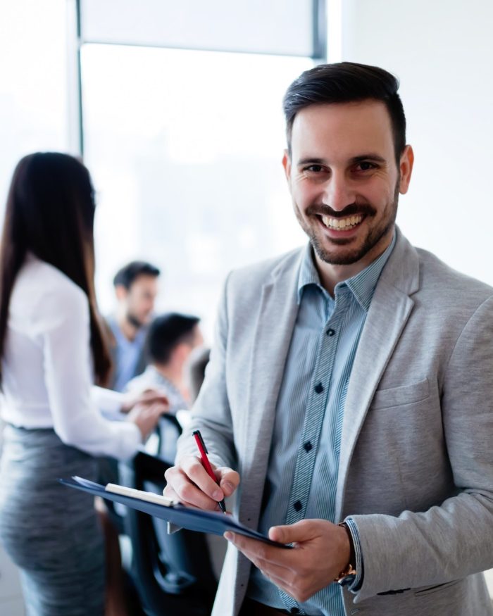 Portrait of happy business working in office