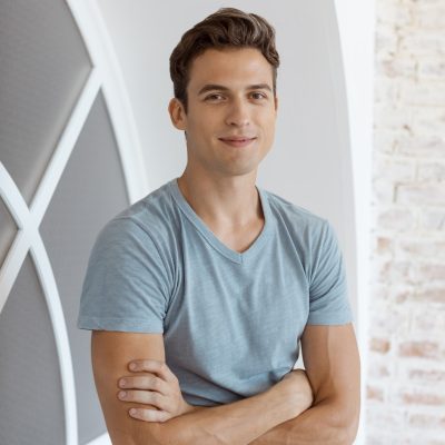 Smiling handsome man near window