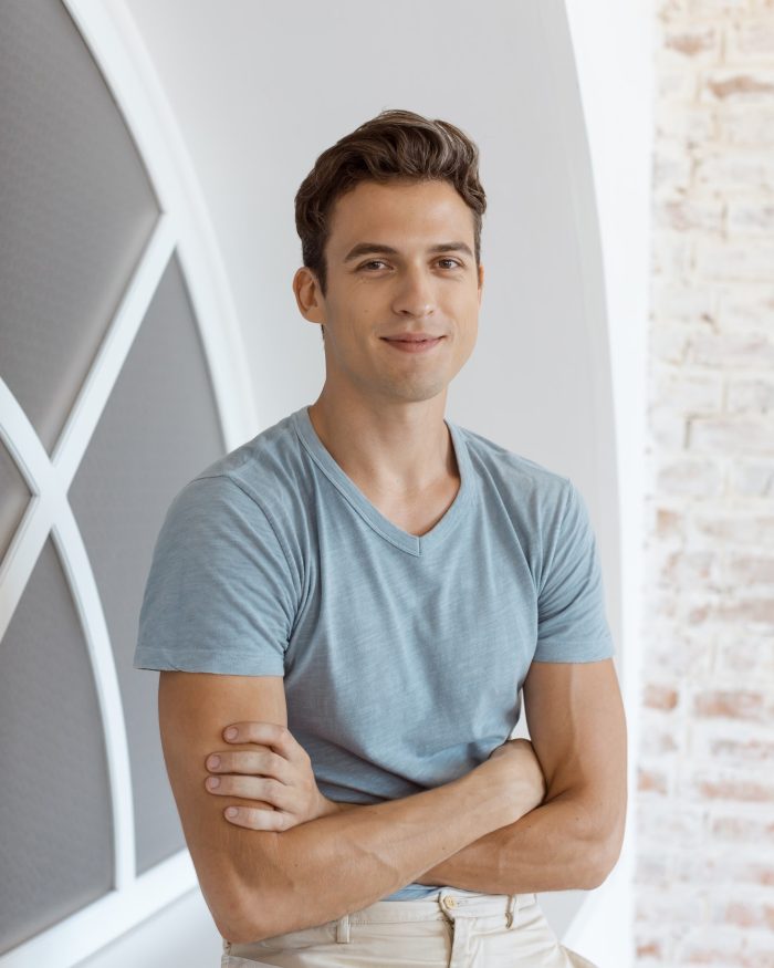 Smiling handsome man near window