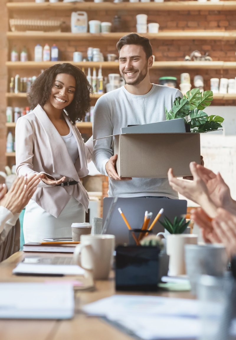 Young multiracial team welcoming cheerful guy newcomer